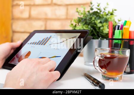 Data analysis concept shown on a tablet held by a woman Stock Photo