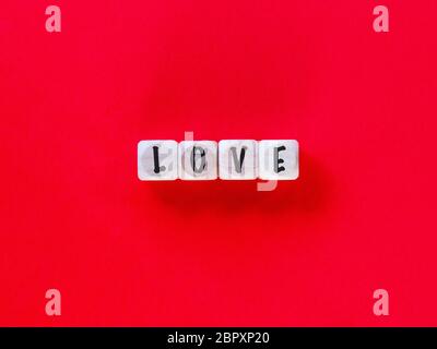 Love isolated on a red background Stock Photo