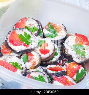 Fried eggplant in mayonnaise with garlic and pieces of red fish Stock Photo