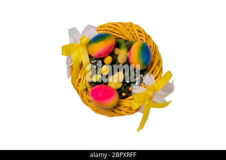 Easter decorations background. Closeup of a yellow Easter wreath with yellow little easter chicks and three easter eggs isolated on a white background Stock Photo