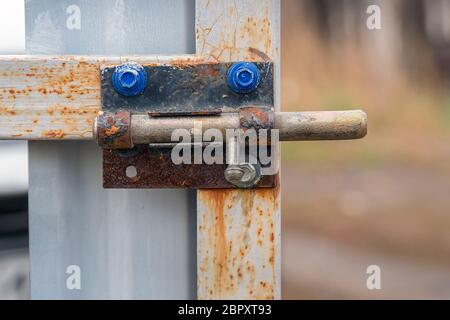 An old rusty latch on the iron gate in the garden Stock Photo