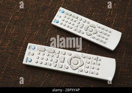 Remote controls on a dark table Stock Photo