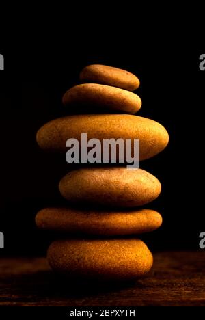 Pile of pebbles on a black background Stock Photo