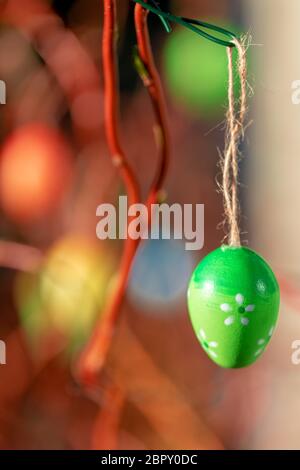 Hanging Easter eggs on tree with soft focus bokeh and color toned. Spring easter concept background. Stock Photo