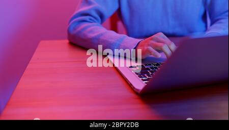 Finger type on keyboard at night Stock Photo