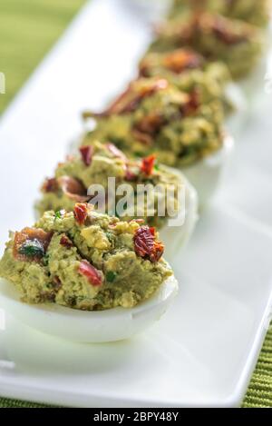 Bacon guacamole deviled eggs Stock Photo