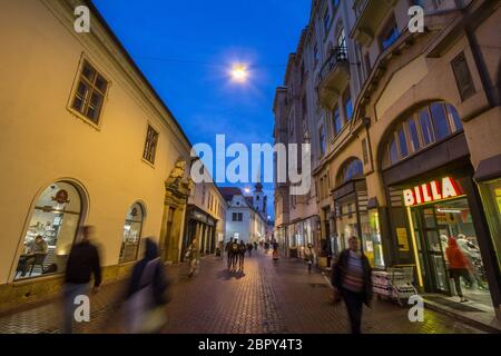 BRNO, CZECHIA - NOVEMBER 5, 2019: Frantiskanske ulice street in the city center of Brno, surrounded by boutiques, at night, with Kostel svate mari mag Stock Photo