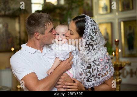 Parents with a child in an Orthodox church Stock Photo