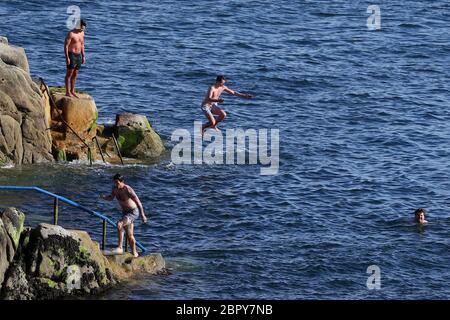 Swimmers at the Forty Foot in Sandycove, Dublin, as the bathing spot has reopened following closures due to the coronavirus pandemic. Stock Photo