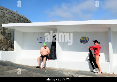 Swimmers at the Forty Foot in Sandycove, Dublin, as the bathing spot has reopened following closures due to the coronavirus pandemic. Mr. Tyndall has been swimming at the Forty Foot for fifty years. Stock Photo