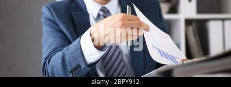 Serious businessman in the office examines documents Stock Photo