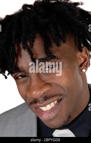 A happy African American mans face in a close up image with his fussy black hair in a suit, isolated for white background Stock Photo