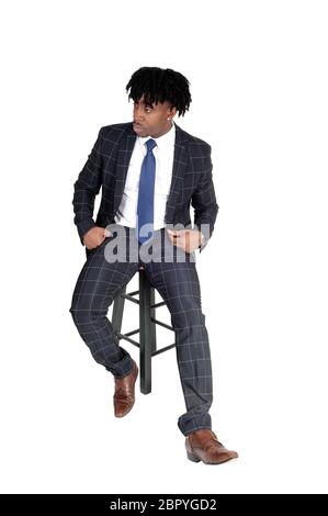 Confident and approachable African-American businessman sits at his ...