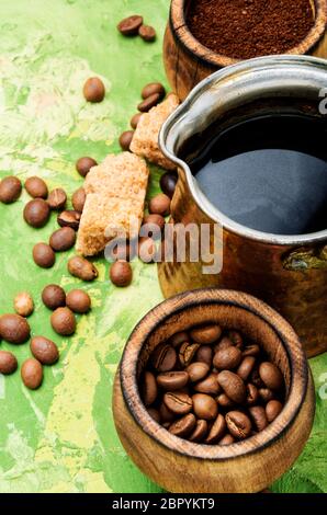 Roasted coffee beans and ground coffee.Coffee on green background Stock Photo