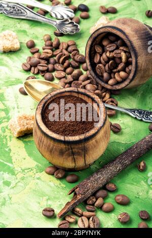 Roasted coffee beans and ground coffee.Coffee on green background Stock Photo