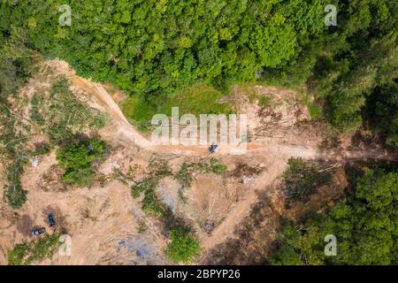 Top down aerial view of deforestation and logging in a tropical rainforest.  Deforestation contributes in a large way to habitat loss and man-made cli Stock Photo