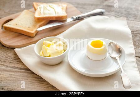 Boiled egg with crispy toasts on the wooden table Stock Photo