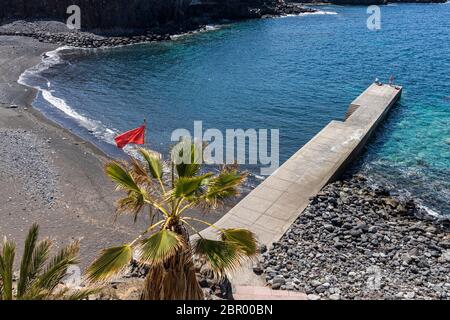 Two fishermen on the pier during phase one of de-escalation of the Covid 19, coronavirus, Playa de Ajabo, Callao Salvaje, State of Emergency, Costa Ad Stock Photo