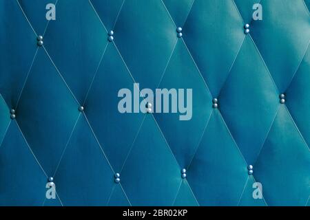Soviet classic blue dermantine front door with a banner of fishing line and nails - full frame background and texture Stock Photo