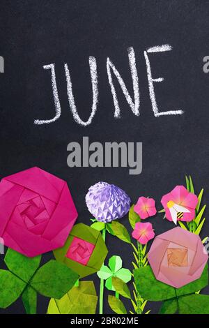 Blackboard with June inscription with origami summer flowers on blackboard background Stock Photo
