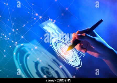 Business hand with markers touching a circle on virtual screen which display the interface of world maps, binary code and business network. Digital te Stock Photo