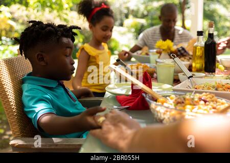 Family eating together at table Stock Photo