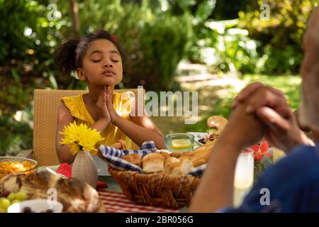 Family eating together at table Stock Photo