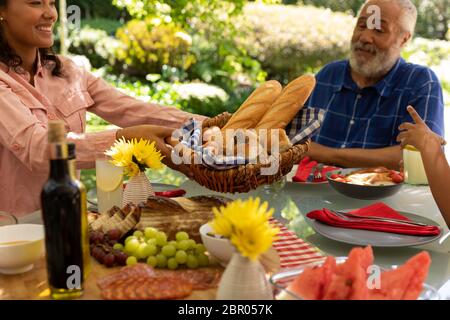 Family eating together at table Stock Photo