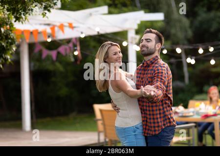 Happy couple dancing in the garden Stock Photo