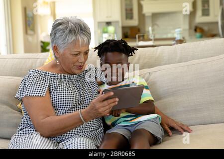 Senior mixed race woman with her grandson at home Stock Photo