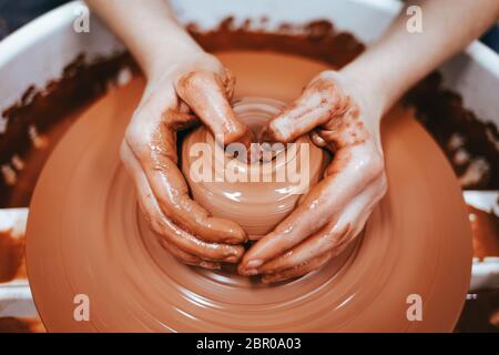 Potter forms clay products into future ceramic dishes. Process of creating clay products close-up Stock Photo