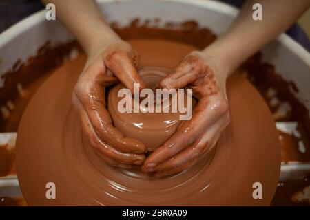 Potter forms clay products into future ceramic dishes. Process of creating clay products close-up Stock Photo