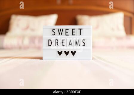 Lightbox with text: sweet dreams, on the bed, copy space. Stock Photo
