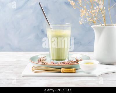 Green matcha tea latte drink in tall glass Stock Photo