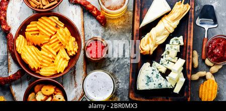 Large selection of snacks for beer. Set of cheeses, fish, chips and snacks Stock Photo