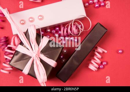 Set of gift boxes with bows, beads and ribbons on a colored background Stock Photo