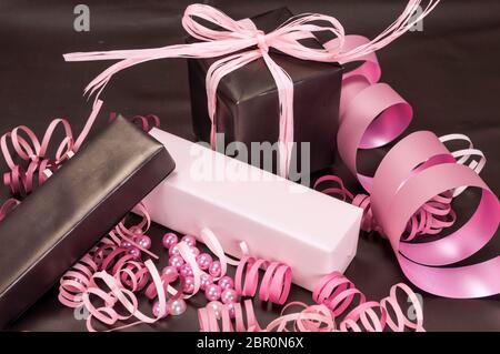 Set of gift boxes with bows, beads and ribbons on a colored background Stock Photo