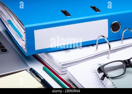 Office Workplace With Laptop And Folders On White Table Stock Photo