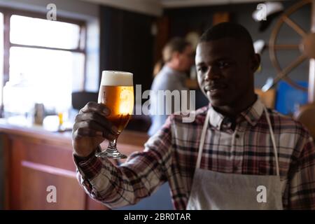 African American man working at a microbrewery pub Stock Photo
