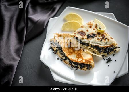 Crepes with black caviar Stock Photo
