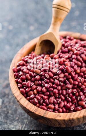 Red adzuki beans in bowl on old kitchen table. Stock Photo