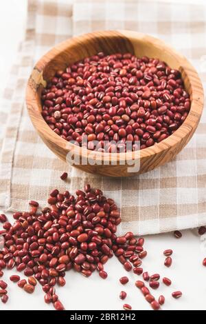 Red adzuki beans in wooden bowl. Stock Photo