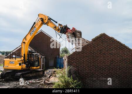 Heavy machinery demolishes private house to make way for development of new Lidl supermarket along Minster Way in Beverley, UK. Stock Photo