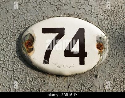 old house number plate No 74 Stock Photo