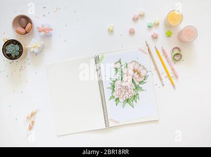 sketch drawing with colored pencils. flowers peonies. Candles, gifts, tea and white background Stock Photo