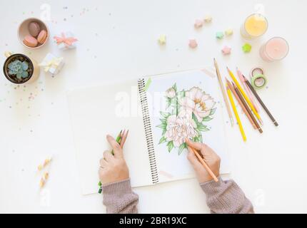 sketch drawing with colored pencils. flowers peonies. Candles, gifts, tea and white background Stock Photo