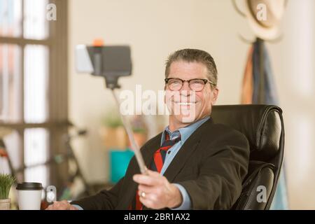 Business man taking a silly selfie Stock Photo