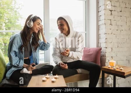 Romantic time. Quarantine lockdown, stay home concept - young beautiful caucasian couple enjoying new lifestyle during coronavirus worldwide health emergency. Happiness, togetherness, healthcare. Stock Photo
