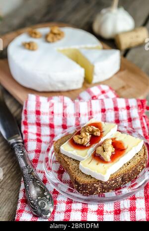 Sliced camembert on the bread Stock Photo