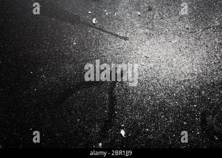 Traces of tools on a black table dusted with white dust. Stock Photo